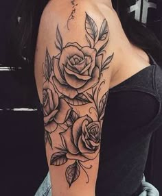 a black and white rose tattoo on the right arm, with leaves around it's edges