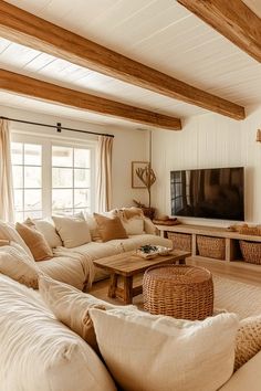 a living room filled with lots of furniture and a flat screen tv mounted on the wall