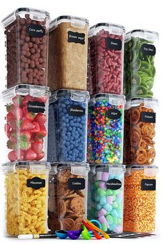 a stack of plastic containers filled with different types of cereals and candies in each container