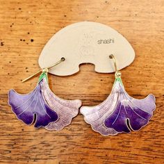 This graceful, Art Nouveau inspired design shows a gingko leaf in dramatic shades of purple. Handcrafted of 24k gold over sterling silver. The enameled earrings have french backs for pierced ears. Size: 1 1/4 inches.The Shashi earrings offered here are vintage stock from the 1970's and 1980's. They were designed by the Shashi Singapuri, crafted by hand, and were part of a line featured on the cover of vogue (quite a handful of times) and numerous other fashion magazines. Iris Earrings, Petals Falling, Enameled Earrings, Cover Of Vogue, Cloisonne Earrings, Gingko Leaves, Replica Jewelry, Blue Dangle Earrings, Laurel Burch