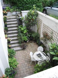 an aerial view of a patio and garden with steps leading up to the back door