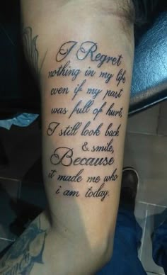 a man with a tattoo on his arm that says, i regret nothing is my last