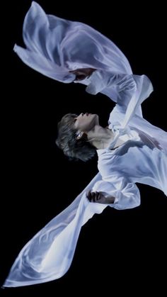 two women dressed in white flying through the air