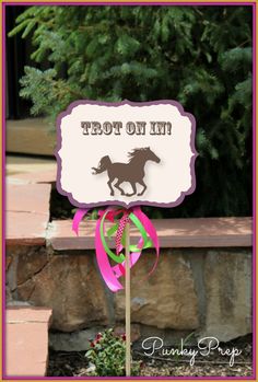 a horse birthday party sign with pink ribbon