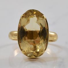 Metal | 10k Yellow Gold  ---|---  Size | 10  Width | Top: 20.50mm, Band: 3.70mm  Gemstone | Oval Cut Citrine  Carat | 11.80ct Classic Formal Faceted Rings, Formal Yellow Gold Round Gemstones, Classic Formal Rings With Faceted Details, Classic Solitaire Gemstones For Formal Occasions, Classic Oval Faceted Topaz Ring, Classic Yellow Faceted Rings, Faceted Gemstones In 14k Gold For Formal Occasions, Classic Oval Citrine Gemstones, Classic Yellow Gold Round Cut Gemstones