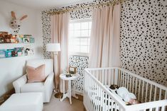 a baby's room is decorated in black and white polka dot wallpapers