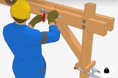 a man in blue overalls working on a wooden beam