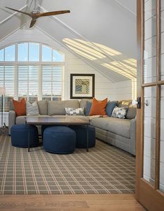 a living room filled with furniture and windows