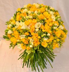 a bouquet of yellow and white flowers