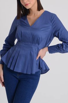 Mila Blouse is a cotton V-neck blouse with long sleeves button cuffs and peplum hem. Concealed size zipper. Classic Fit. Material: 100% Cotton. Model wears size 'S'. V-neck Blouse With Pleated Sleeves, Elegant V-neck Peplum Top For Fall, Fall Elegant V-neck Peplum Top, Elegant Fall V-neck Peplum Top, Chic Cotton Long Sleeve Top For Work, Peplum Blouse With Ruffle Hem For Work, Elegant Cotton V-neck Blouse, Fall Pleated Sleeve V-neck Blouse, Elegant Fitted Long Sleeve Peplum Top