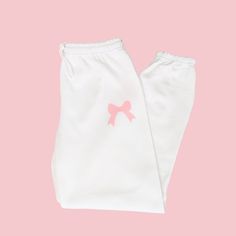 🛒Introducing the Pink Bow Soft Girl Era Sweatpants, the perfect mix of comfort and style! With an elastic waistband, these preppy sweats pants will keep you on-trend while still feeling cozy. Embrace the coquette trend with these trendy lounge pants. 📦FREE SHIPPING on orders $35 or more to US shoppers 👕Brand = Gildan 🧵Fabric = 50% Cotton / 50% Polyester ✂️Design = Blush Pink heat-applied vinyl 🎨Color = White -Colors will vary from computer to computer and monitor to monitor. -The colors shown may not be an exact representation. -Slight shade variations of garment colors are likely in the pigment dye process. 📏Sizing = Unisex -Please see size chart in photos -Sweatpants have more of an oversized fit -Drawstring elastic waistband, elastic cuffs and no pockets -Model is 5'0 and wearing Cute Pink Pants With Elastic Waistband, Cute Cotton Pants With Elastic Waistband, Cute Pink Cotton Pants, Pink Cotton Sweatpants For Pajama Party, Cute Cotton Bottoms With Elastic Waistband, Cotton Sweatpants With Elastic Waistband For Sleepover, Cute Bottoms With Elastic Waistband, Cute White Long Pants, Cute White Bottoms For Sleepover