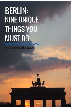 the sun is setting behind a monument with an image of people on horseback in front of it