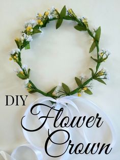 the diy flower crown is made with white flowers and green leaves