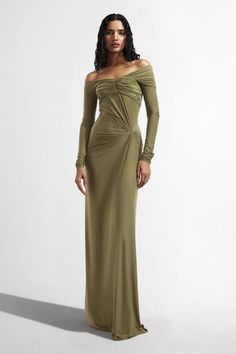 Sage green draped dress with off-shoulder sleeve detailing.
Components: 1
Type Of Work: Plain
Neckline: Straight
Sleeve Type: Full sleeves
Fabric: Malai Lycra
Color: Green
Other Details: 
Model height: 5 ft 10 inches, wearing size S
Pleated bodice
Occasion: Cocktail - Aza Fashions Off The Shoulder Long Sleeve Dress, Lycra Dress Styles, Drape Gowns Indian, Guest Checklist, Draped Gown, Green Plain, Drape Gowns, Drape Maxi Dress, Off Shoulder Gown