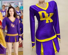 a woman in purple and yellow uniform next to a mannequin dressed as a cheerleader