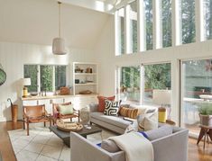 a living room filled with furniture and lots of windows