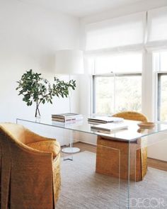 a living room with two chairs and a glass table