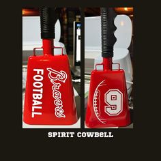 two red bell shaped objects with the words spirit cowbell written on them and an image of a football helmet