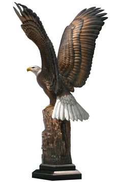 a statue of an eagle is shown on a white background and has its wings spread out