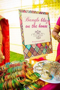 a table with bangles on it and a sign that says bangle bling on the house