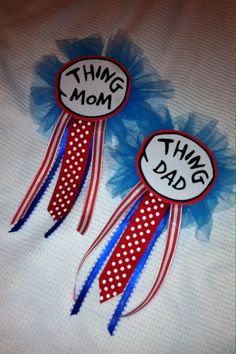 two red, white and blue ribbons with the words thing mom on them are sitting next to each other