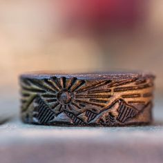 a close up of a ring on top of a wooden table with a blurry background