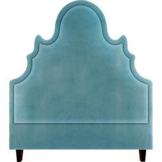 an upholstered headboard with scalloped details in aqua blue velvete