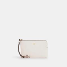 Compact yet chic, the Corner Zip Wristlet boasts pebble leather construction in a crisp white hue. Its credit card slots and zip-top closure keep essentials like IDs, cards, and cash conveniently stored yet secure while on the go. Beyond functionality, this petite wristlet lends polish to any outfit with just a hint of the beloved Coach signature. Lightweight and versatile, you’ll want to wear it daily regardless of your plans. Classic Pouch Wallet With Wrist Strap, Classic Bags With Wrist Strap, Coach Leather Wristlet With Zipper Closure, Classic Wristlet With Wrist Strap For Daily Use, Coach Leather Clutch With Card Slots, Elegant Leather Wristlet With Card Slots, Coach Leather Wristlet With Removable Pouch, Classic Formal Wristlet With Zipper Closure, Coach Wallet With Wrist Strap For Everyday Use