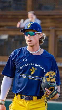 a baseball player in blue and yellow holding a catchers mitt