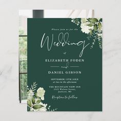 a wedding card with white flowers and greenery on the front, in dark green