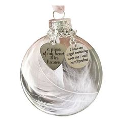 a glass ornament with two heart shaped tags hanging from it's side