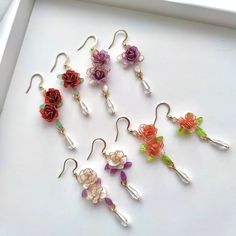 Handmade Colorful Rose Flower Earrings These unique handmade earrings feature a beautifulrose design. Crafted from high quality materials, they make a perfect gift for the special someone in your life. Show your loved one how much you care with these stunning rose earrings. Detail: - Size of earring: 50mm Material: flowers - resin; ear wires - sterling silver The Handmade Rose Flower Earrings are sold in pairs of two earrings. Dangle Flower Earrings With 3d Flowers For Gifts, Gift Flower Dangle Earrings With 3d Flowers, Dangle Earrings With 3d Flowers For Gift, Handmade Flower Drop Earrings As Gift, Whimsical Flower Shaped Earrings Gift, 3d Flower Dangle Earrings As Gift, Whimsical Earrings With 3d Flowers For Gift, Handmade Adjustable Flower Earrings For Gift, Whimsical Handmade Flower Earrings For Gift