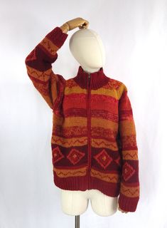 A vibrant hand knitted, lined, chunky wool cardigan/jacket.  Size: 14 UK M medium  Bust: 42"  Pit to pit: 21" Pit to cuff: 17" Collar to cuff: 26.5" Length: 23.5" She is in lovely condition and comes from a smoke free home.  Please do contact us for more information or if you would like to combine postage on multiple items. Orange Knitted Outerwear For Winter, Retro Orange Cardigan For Winter, Bohemian Orange Winter Outerwear, Winter Orange Knitted Outerwear, Winter Knitted Orange Outerwear, Cozy Chunky Knit Red Outerwear, Chunky Knit Vest, Orange Wool Winter Outerwear, Retro Orange Winter Cardigan