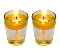 two yellow candles sitting next to each other