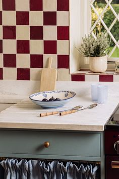 a kitchen counter with a plate and utensils on it