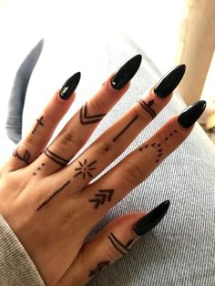 a woman's hand with tattoos on it