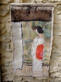 a piece of fabric hanging on the side of a building with an image of a woman