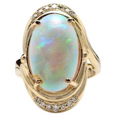 5.35 Carats Natural Impressive Ethiopian Opal and Diamond 14K Solid Yellow Gold Ring The opal has beautiful fire, pictures don't show the whole beauty of the opal! Total Natural Opal Weight is: 5.00 Carats Opal Measures: 17.88x 11.20mm Total Natural Round Diamonds Weight: .35 Carats (color G / Clarity VS2-SI1) Ring size: 7 (we offer free re-sizing upon request) Ring total weight: 9.3 grams Disclaimer: all weights, measurements and colors are approximate and may vary slightly from the listed dime Opal Diamond Engagement Ring, Fire Pictures, Yellow Gold Cocktail Ring, Ethiopian Opal Ring, Fire Opal Ring, Gold Statement Ring, Gold Cocktail Ring, Yellow Gold Engagement Rings, Pretty Rings