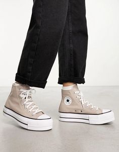 Elevate your Instagram feed and style with the iconic Converse Chuck Taylor All Star lift trainers in cool stone grey. Featuring a classic high-top silhouette with lace-up closure and signature All Star branding, these kicks offer eye-catching retro aesthetic. The built-in platform sole provides subtle yet stylish height boost for everyday looks. Breathable eyelets, vulcanized rubber toe cap and flexible archival tape create durable comfort no matter your adventures. With lightweight cushioning Converse And Dress, Converse Plateau, Tan Converse, Converse Haute, Beige Converse, Star Branding, Converse Outfits, Chuck Taylor All Star Lift, Converse Trainers