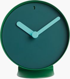 a green clock with white hands on a white background