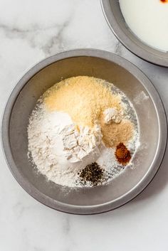 two bowls filled with different types of food on top of a white marble countertop