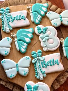 decorated cookies are arranged on a wooden tray