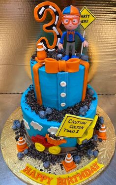 a birthday cake with an image of a construction worker on top