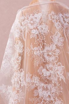 the back of a wedding veil with flowers on it