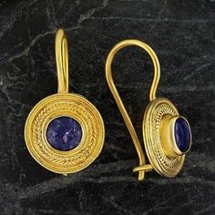 Handcrafted of a tiny disc of filigree thread, this classic Greek design highlights the beauty of a single amethysts are subtle yet undeniably brilliant. 24k gold over sterling silver; hinged backs. Size: 7/8 Inches. Ceremonial Gold Gemstone Earrings, 22k Gold Filigree Round Jewelry, Gold Amethyst Dainty Earrings, 22k Gold Filigree Jewelry, Dainty 22k Gold Round Jewelry, Dainty Gold Amethyst Earrings, Dainty 22k Gold Jewelry, Gold Amethyst Round Earrings, Byzantine Round Hallmarked Jewelry