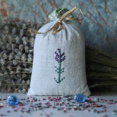 a small bag filled with purple flowers on top of a table