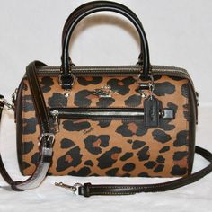 Coach Rowan Satchel With Leopard Print Color Light Saddle Multi Silver Hardware Signature Coated Canvas, Printed Coated Canvas And Smooth Leather Inside Zip And Multifunction Pockets Zip Closure, Fabric Lining Handles With 4 1/4" Drop Outside Zip Pocket Detachable Strap With 23" Drop For Shoulder Or Crossbody Wear 10 1/2" (L) X 6 1/4" (H) X 5 1/2" (W) Brand New With Tag 100% Authentic! Ships Fast From A Smoke Free Home. Coach Rowan Satchel, Leopard Print Handbags, Favorite Purse, Signature Canvas, Coach Leather, Coach Purses, Cheetah Print, Silver Hardware, Color Light