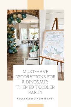 a dinosaur themed birthday party with balloons and decorations on the wall, including a sign that says