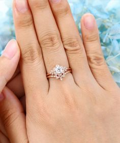 a woman's hand holding an engagement ring