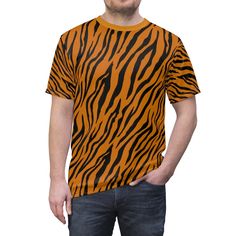 This tee was created to be a versatile and stylish companion for all your casual appearances. With its uniquely textured, thick, microfiber-knit fabric, this t-shirt bears a premium, soft feel that remains lightweight and highly breathable - the perfect combo for a hot day or layering. .: 100% Polyester .: Light fabric (4.0 oz/yd² (113 g/m / (6.0 oz/yd² (170 g/m .: Regular fit .: Tagless .: Runs true to size 🛍️Return Policy At Just Simply Dad Designs, we are committed to providing you with high-quality, custom-made products that are created with care and attention to detail. We want you to love your purchase, and we strive to ensure your satisfaction with every order. Please take a moment to review our return policy to understand how we handle returns and exchanges. 🚫 Please Note: Our Pr Casual T-shirt With All Over Print And Relaxed Fit, Casual Relaxed Fit T-shirt With All Over Print, Casual Orange Tops With Custom Print, Relaxed Fit All Over Print Crew Neck T-shirt, Orange Crew Neck Top With Custom Print, Casual Cotton Tops With Tiger Print, Casual Yellow T-shirt With All Over Print, Casual Cotton Tiger Print Tops, Yellow Casual T-shirt With All Over Print